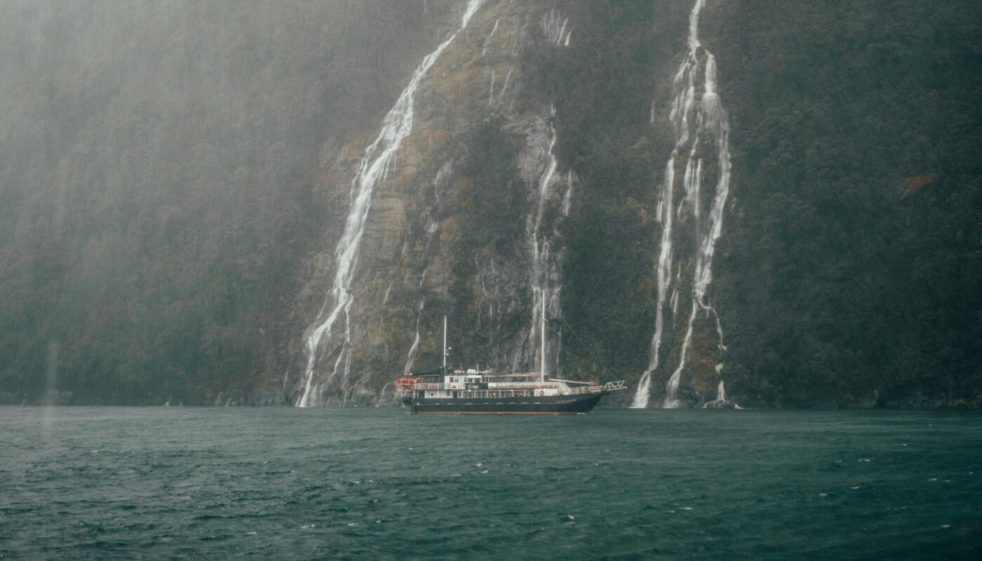 https://www.pexels.com/photo/passenger-ship-near-waterfall-on-sea-shore-13131499/